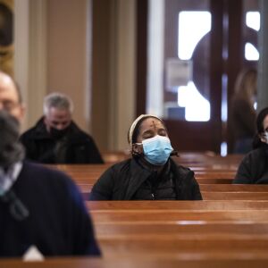 Congregants pray after receiving the imposition of ashes from Father Tom Hurley at Old St. Patrick’s Catholic Church on the Near West Side on Ash Wednesday, Feb. 17, 2021.