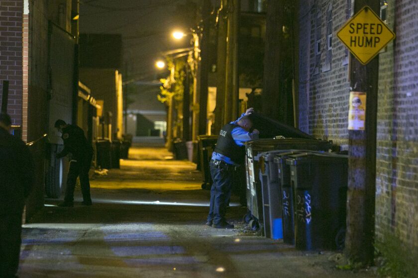 Police investigate outside FoodSmart Urban Market, 2901 W. Armitage Ave., where two men were shot Wednesday night, May 13, 2015. | Ashlee Rezin/for Sun-Times Media