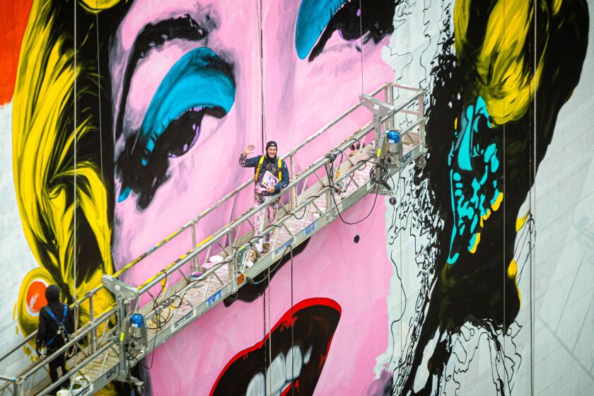 Mural artist Jeff Zimmerman and his not-quite-finished Marilyn Monroe mural at 633 N Michigan Ave.