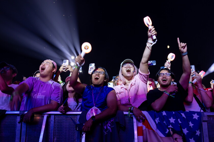 TWICE fans, collectively known as ONCE, cheer for the K-pop girl group at the Bud Light stage during day three of Lollapalooza on Saturday.