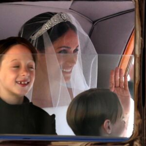 Page boys John and Brian Mulroney accompany Meghan Markle as she arrives for her wedding. | CHRIS RADBURN/AFP/Getty Images
