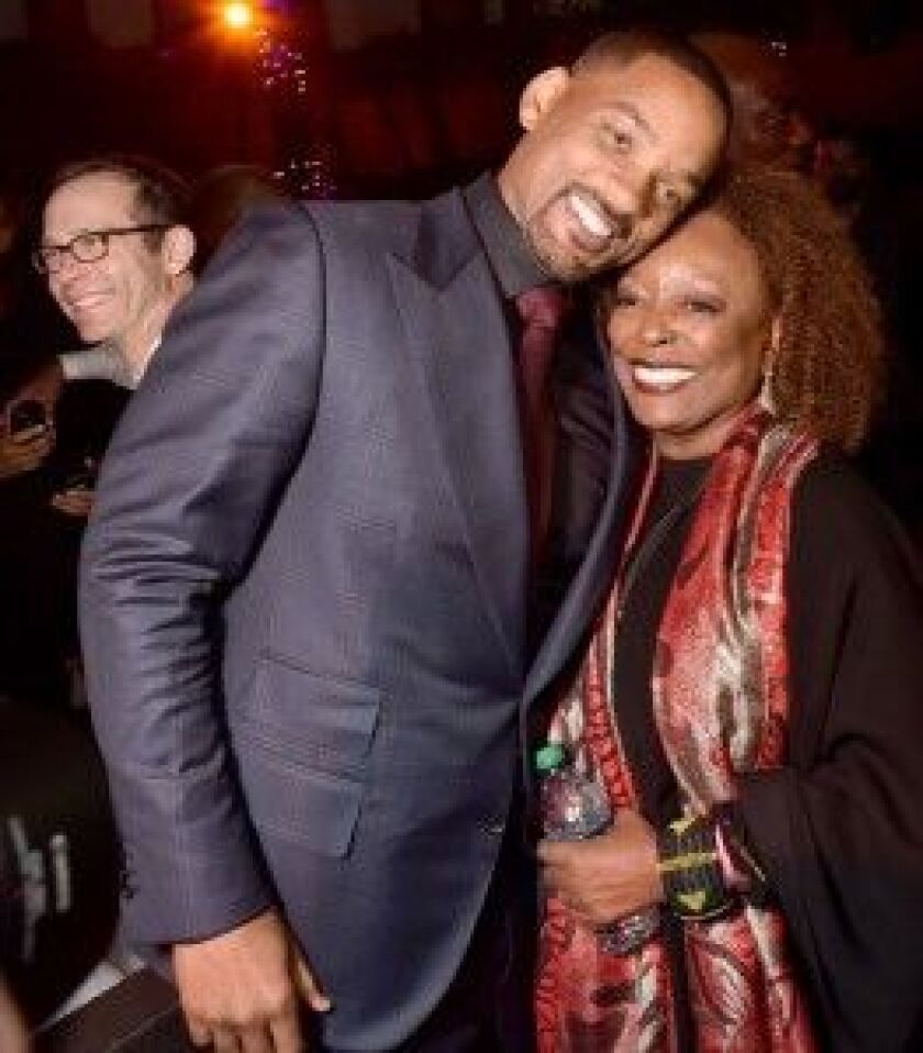 Will Smith greets his “Concussion” co-star L. Scott Caldwell at a premiere for the film. | Kevin Winter/Getty Images