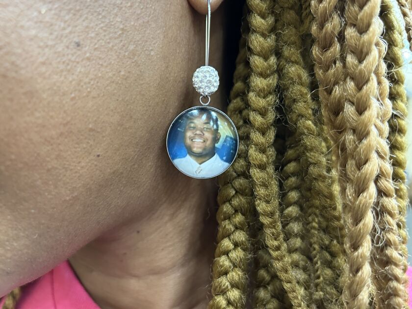 Pamela Bodley wears earrings with a picture of her son Terrell, who was fatally shot in Chicago in 2006.