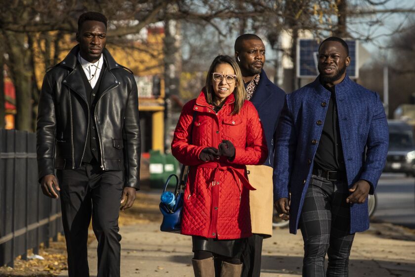 (From left) Abimbola Osundairo, attorney Gloria Schmidt Rodriguez and Olabinjo Osundairo walk into the Leighton Criminal Courthouse for the Jussie Smollett trial on Dec. 2, 2021.