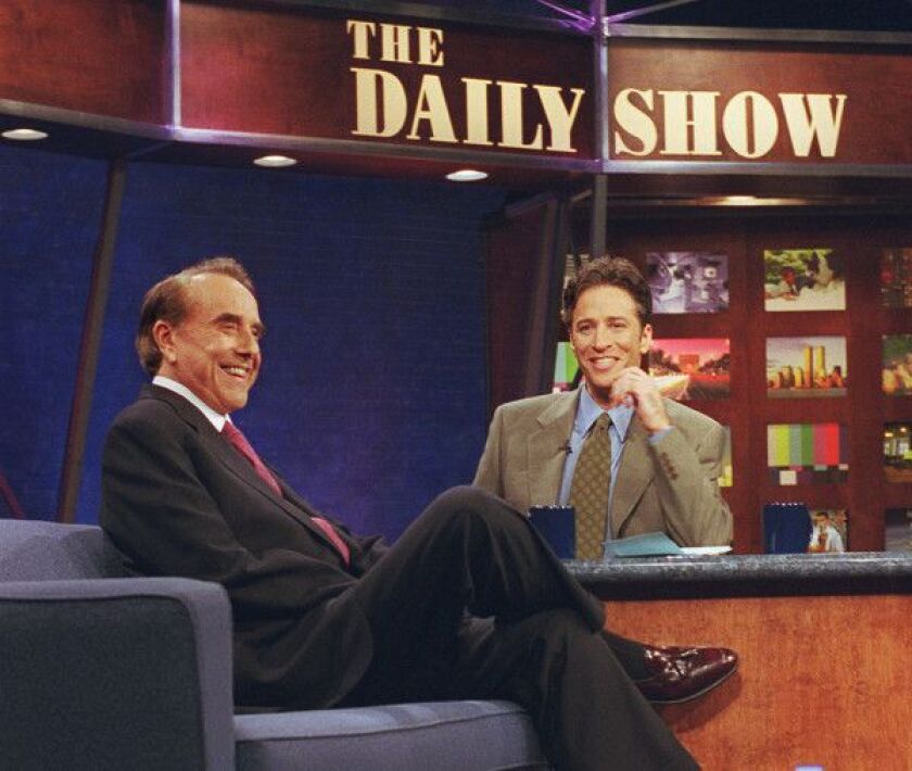Jon Stewart, host of “The Daily Show,” interviews Sen. Bob Dole on the set of the comedy show in New York, in this Dec. 7, 1999, file photo. CNN has signed Stewart of Comedy Central to make a weekly version of his satirical news program to air late at nig