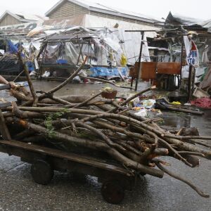 A resident pushes a cart full of wood as he passes market stalls destroyed by strong winds as Typhoon Mangkhut barreled across Tuguegrao city in Cagayan province, northeastern Philippines on Saturday, Sept. 15, 2018. The typhoon slammed into the Philippin