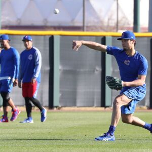 Yu Darvish throws a baseball while Duane Underwood Jr. and Jen-Ho Tseng walk in the background on field 1 at Riverview Park, the Spring Training home of the Chicago Cubs, in Mesa, AZ. | John Antonoff/For the Sun-Times