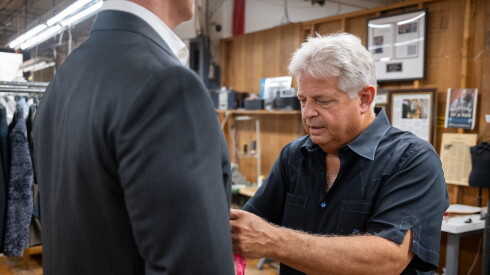 Jay Greenfield measures a customer for a suit at Martin Greenfield Clothiers in Brooklyn, New York, on August 11, 2026.
