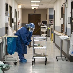 Nurse Jeanette Averett delivers dinner trays in the COVID-19 unit at Roseland Community Hospital on the Far South Side, Tuesday afternoon, April 28, 2020. During a standard 12-hour day shift Tuesday, nurses responded to five code blues and three patients died of the coronavirus.