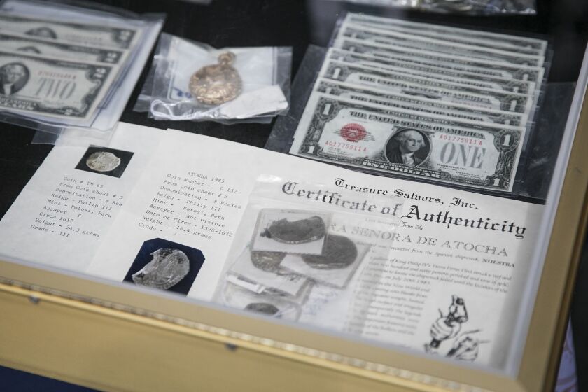 Gold coins from the 1622 shipwreck of the Atocha, recovered in 1985, each of which comes with a certificate of authenticity, are among an array of the state’s unclaimed valuables that will be auctioned off during the Illinois State Fair. | Ashlee Rezin/Su