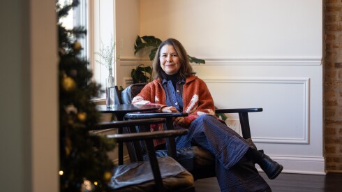 Wicker Park Inn owner Laura Yapez sits in chair