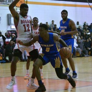 Simeon’s Kejuan Clements (0) storms past Bogan’s Rashuan Agee (12). Worsom Robinson/For the Sun-Times.