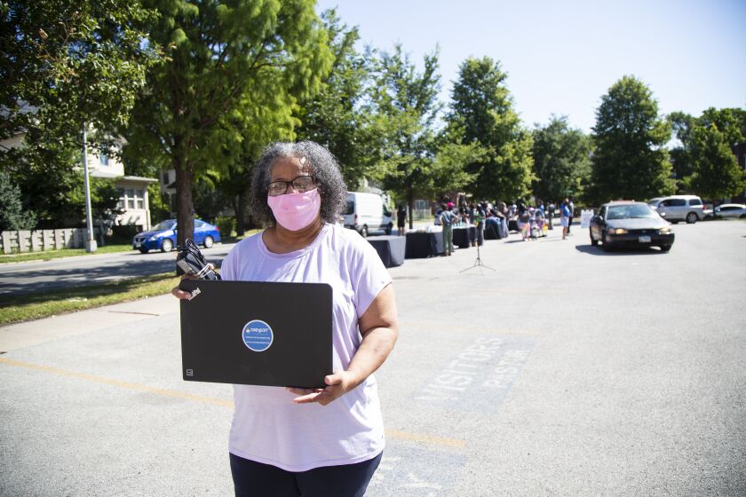 Sharon Baker with a laptop she received at Something Good in Englewood computer giveaway at 6701 S. Emerald Ave, In Englewood, Thursday, Aug. 20, 2020. | Anthony Vazquez/Sun-Times