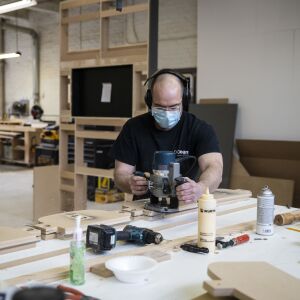 Jason Wade, lead carpenter at Pac Team, uses a template to cut plastic for face shields at the factory at 4447 W. Armitage Ave. on the Northwest Side, Tuesday afternoon, March 31, 2020.
