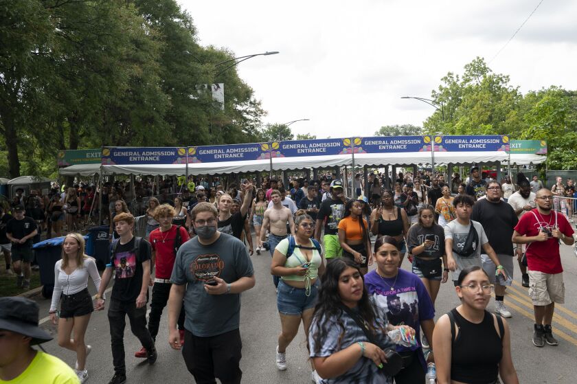 Summer Smash Festival attendees begin to evacuate Douglass Park as sever weather moves in.
