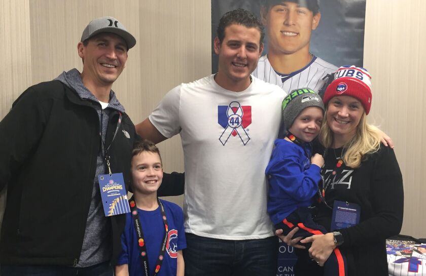 Chicago Cubs first baseman Anthony Rizzo with Ethan’s father, Brian Hugins (left), and his son, Jack, while Ryanne Hugins holds her son, Ethan. | Family photo