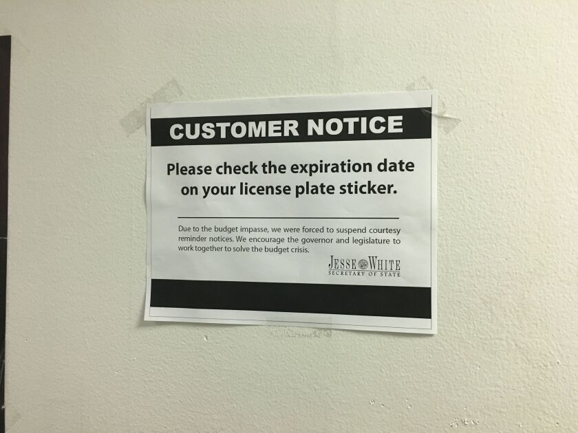 A post on a wall at the Secretary of State facility at the Thompson Center advises drivers to check sticker expiration dates. | Mitch Dudek/Sun-Times