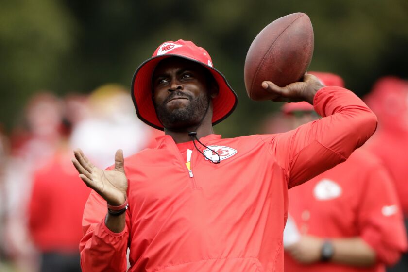 Former NFL quarterback Michael Vick, who spent the summer working as a coaching intern with the Kansas City Chiefs, will be a Fox Sports football analyst. | Charlie Riedel/AP