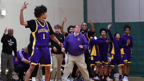 Waukegan's Ryan Brown (1) celebrates with teammates after hitting a three to take the lead against Oswego East at the end of the second quarter of the game at Hope Academy.