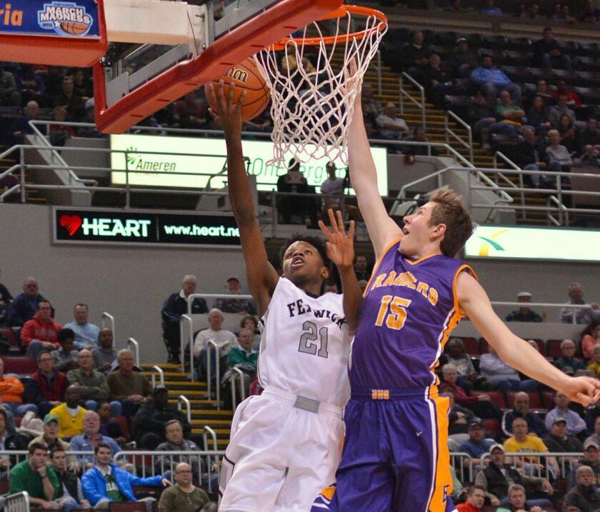 Fenwick’s D.J. Steward (21) gets a finger roll on Bloomington’s Colton Sandage (15). Worsom Robinson/ For the Sun-Times.