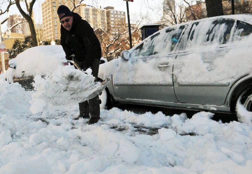 Jim Croke of Sandberg Village works to free his car from the snow near Schiller and Clark. | Al Podgorski / Sun-Times Media
