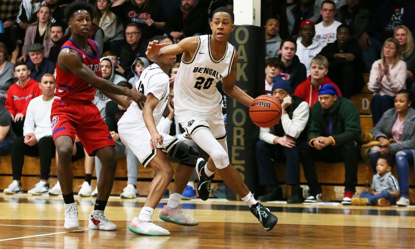 Oak Forest’s Jayson Kent (25) drives the baseline toward the basket.