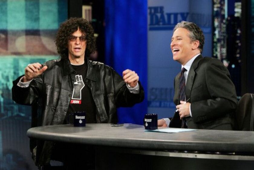 Radio personality Howard Stern talks with Jon Stewart during “The Daily Show With Jon Stewart” at the Daily Show Studios December 13, 2005 in New York City. (Photo by Scott Gries/Getty Images)