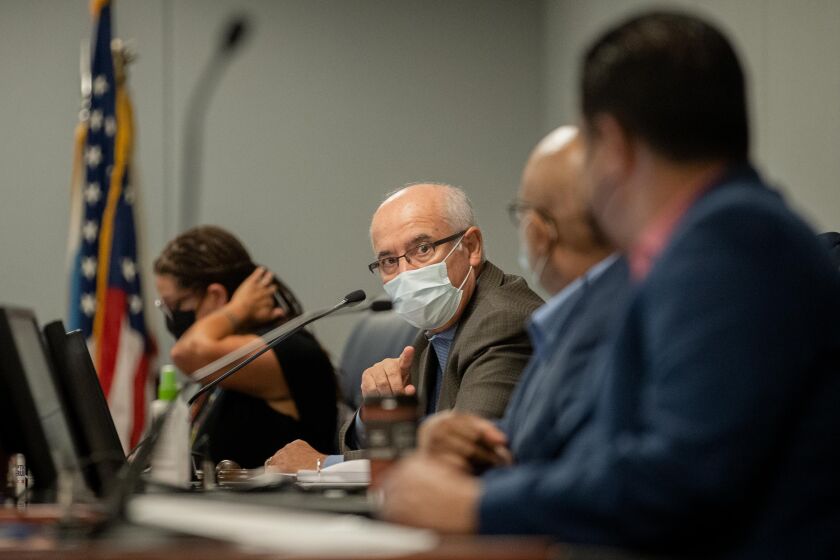 Chicago Board of Education President Miguel del Valle talks to members during a Chicago Board of Education meeting at the Chicago Public Schools headquarters in the Loop, in August.