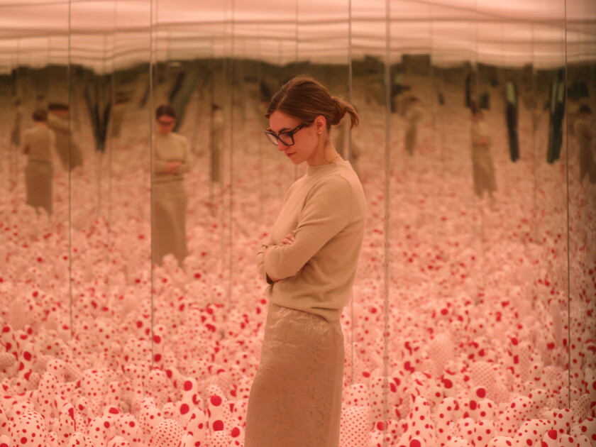Assistant curator is reflected in a mirror as she talks about the art of Yayoi Kusama in a mirrored infinite room at Wrightwood 659 in Chicago, Illinois, U.S., September 23, 2026.