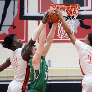 York’s Sam Walsh (35) battles for the rebound between Whitney Young’s Sangolay Njie (1) and Justin Warren (11) in their 58-56 loss in Hillside, Wednesday, March 6, 2019. | Kevin Tanaka/For the Sun Times