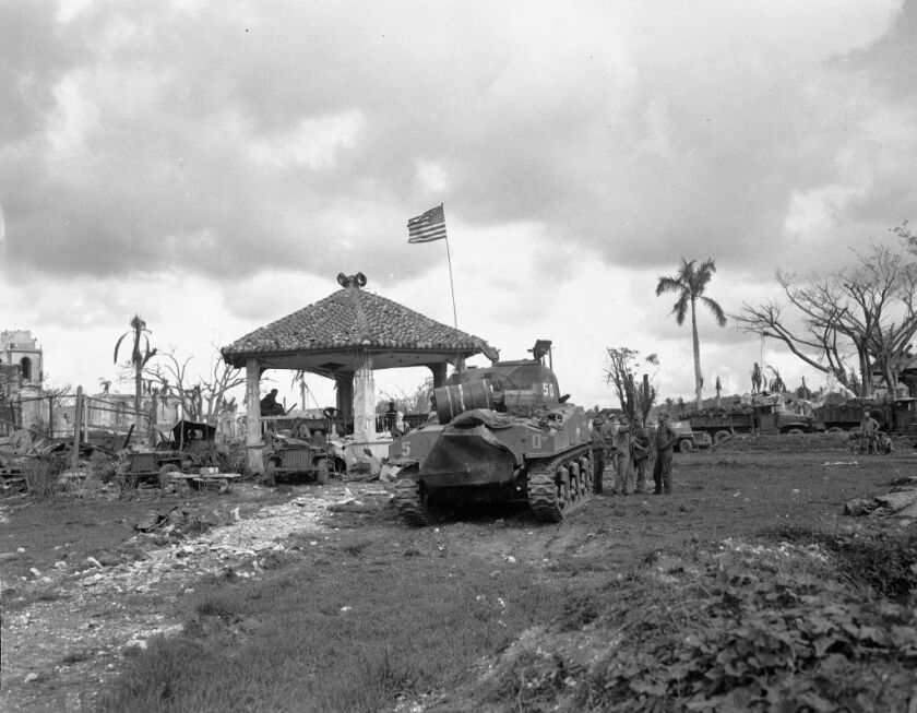 This August 1944 file photo shows an American flag atop the first U.S. tank to lead the push to Agana, capital of Guam. The small U.S. territory of Guam has become a focal point after North Korea’s army threatened to use ballistic missiles to create an “e