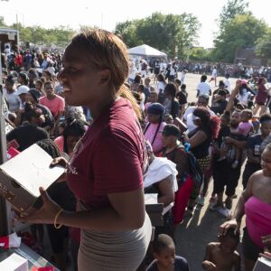 Crowds mass behind “anti-bait” trucks for free shoes. | Rick Majewski/For the Sun-Times