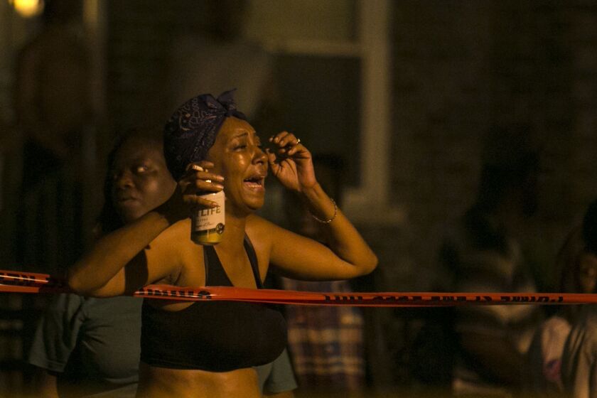 A woman reacts to a fatal shooting early Tuesday in the 300 block of West 42nd Street. | Ashlee Rezin/For the Sun-Times