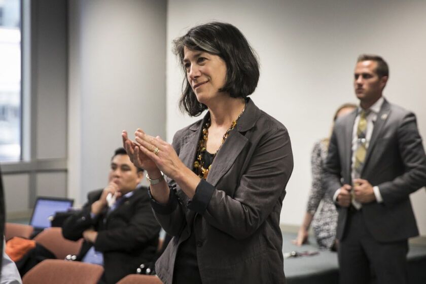 First lady Diana Rauner smiles and applauds from the back of the room as Gov. Bruce Rauner announces he will sign abortion legislation HB40. | Ashlee Rezin/Sun-Times