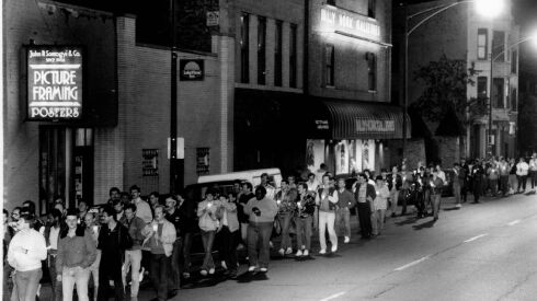 People march in a memorial and candlelight vigil on North Halsted Street in memory of those who died of AIDS on May 27, 1985.
