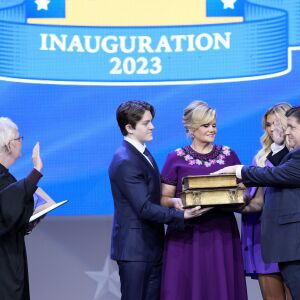 Illinois Gov. J.B. Pritzker, right, takes the office from Mary Jane Theis, Illinois Supreme Court Chief Justice as his wife M.K. Pritzker, son Don, daughter Teddi watch during ceremonies Monday, Jan. 9, 2023, in Springfield, Ill.