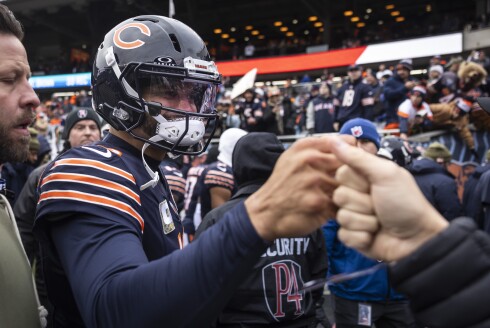 Bears quarterback Caleb Williams fist bumps a supporter on the field before the Bears take on the New York Giants at Soldier Field on Sunday, Nov. 9, 2025.