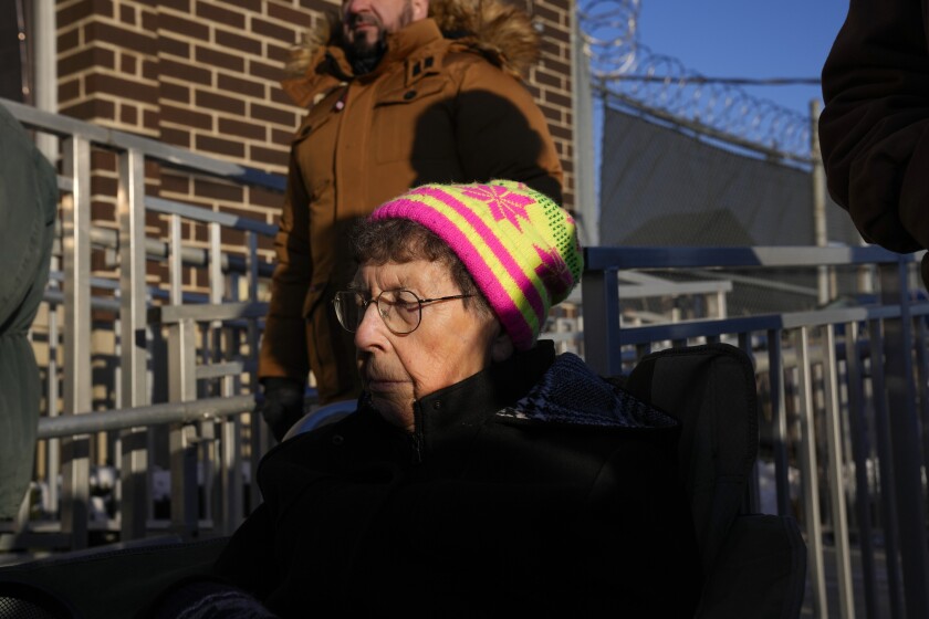 Sister JoAnn Persch prays outside the immigration processing center in Broadview.
