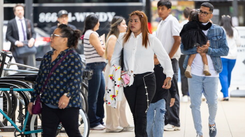 A family joins others heading into Chicago's immigration court building in the Loop on Wednesday