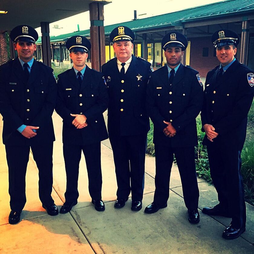 Officer Timothy Jones, second from right, after taking the oath of office last Sept. 22 at a village board meeting. Also, from left, are: Officer Haytham Elyyan, Officer Christopher Batzel, Chief Peter Green and Officer Jack Rasmas. Park Forest Instagram