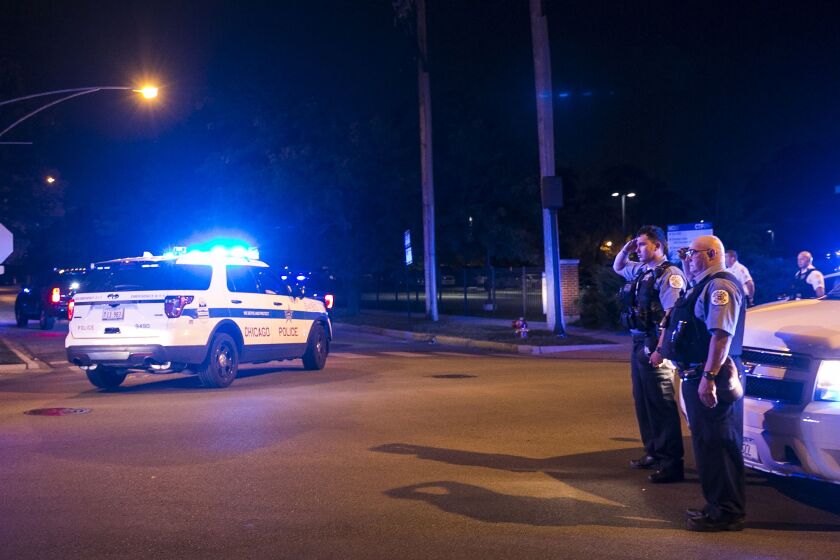 Chicago Police officers salute during the process to the Cook County medical examiner’s office after a CPD supervisor was found unconscious in his squad car and later pronounced dead at Trinity Hospital, early Sunday, Aug. 13, 2017. | Ashlee Rezin/Sun-Tim