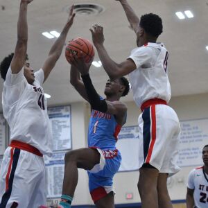 Kenwood’s Artese Stapleton (1) splits St. Rita’s defense. Worsom Robinson/For the Sun-Times.