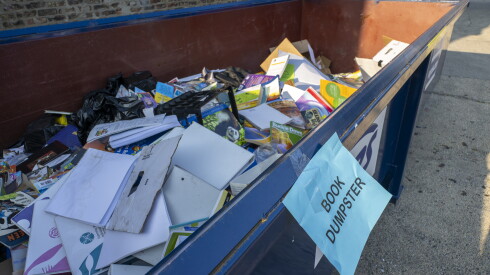 A dumpster filled with school books sits outside Santiago Elementary School in Ukrainian Village.