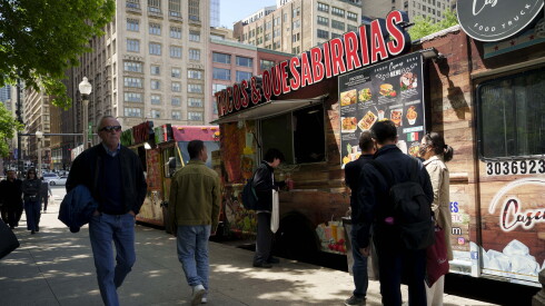 Caseras Sabor Real food trucks are parked on East Monroe Street near South Michigan Avenue in the Loop.