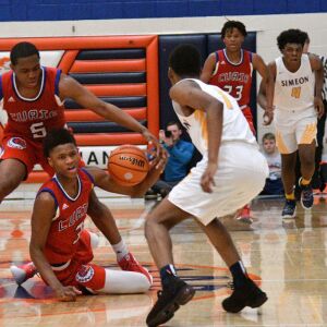 Curie’s DaJuan Gordon (3) slips in front of Simeon’s Jaylen Drane (1), Saturday 12-29-18. Worsom Robinson/For Sun-Times