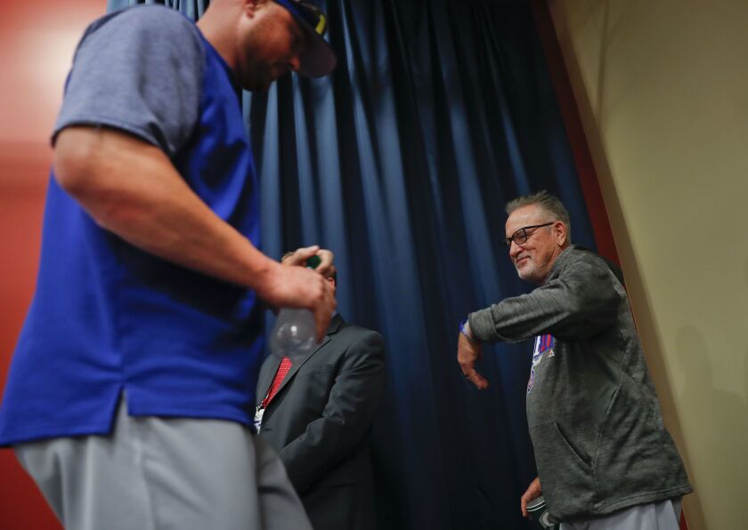 Cubs manager Joe Maddon, right, walks past his pitcher Jon Lester, left, during a media availability.