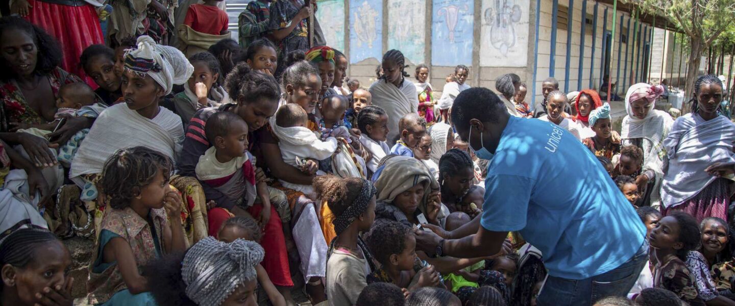 UNICEF nutrition specialist Joseph Senesie (right) screens children for malnutrition in Adikeh, in the Wajirat district of the Tigray region of northern Ethiopia.