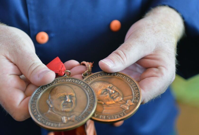 <small><strong>Art Smith polished up a couple of his past James Beard awards to bring to last year’s announcement that the awards gala was being held in Chicago for the next three years. | Sun-Times File Photo</strong></small>