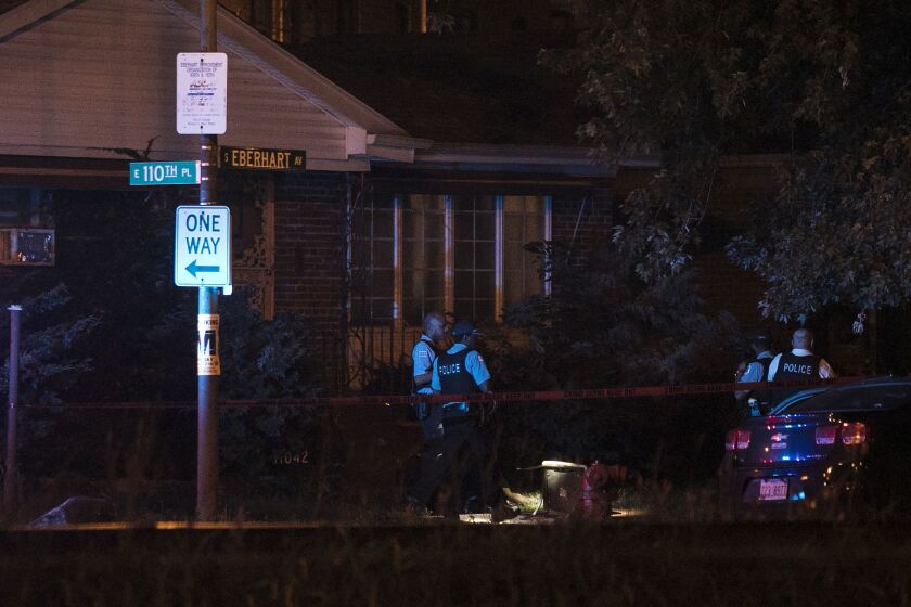 Chicago Police investigate near 110th Place and Eberhart Avenue, where two men were killed and two others were wounded in a shooting early Wednesday, July 5, 2017. | Ashlee Rezin/Sun-Times