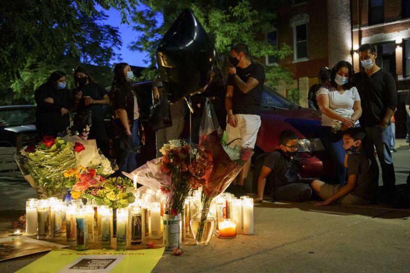 Family members and mourners gather around a memorial during a vigil for Miguel Vega two days after he was shot to death by a Chicago police officer in the 1300 block of West 19th Street in Pilsen, Wednesday night, Sept. 2, 2020. Vega, 26, was shot and killed by an officer on Aug. 31 during an exchange of gunfire with a group of people in the Southwest Side neighborhood, police said.
